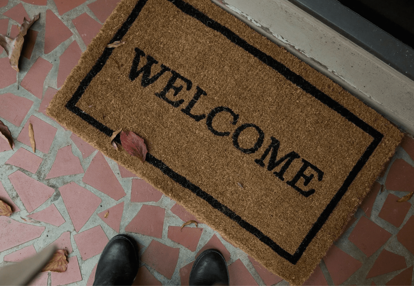 Welcome mat at the front door of a home.