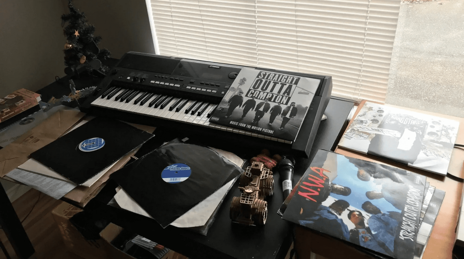 Electronic keyboard with record player CDs.