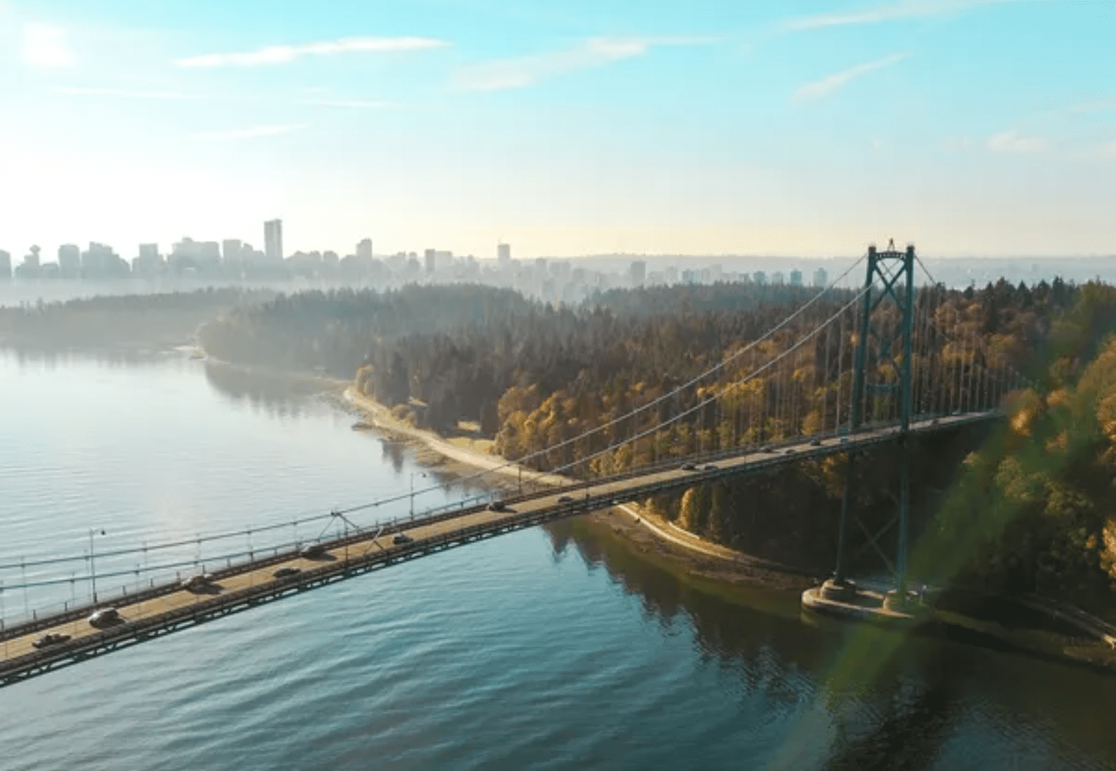 View of Lions Gate Bridge surrounded by greenery, with the sea and forest in Vancouver, BC