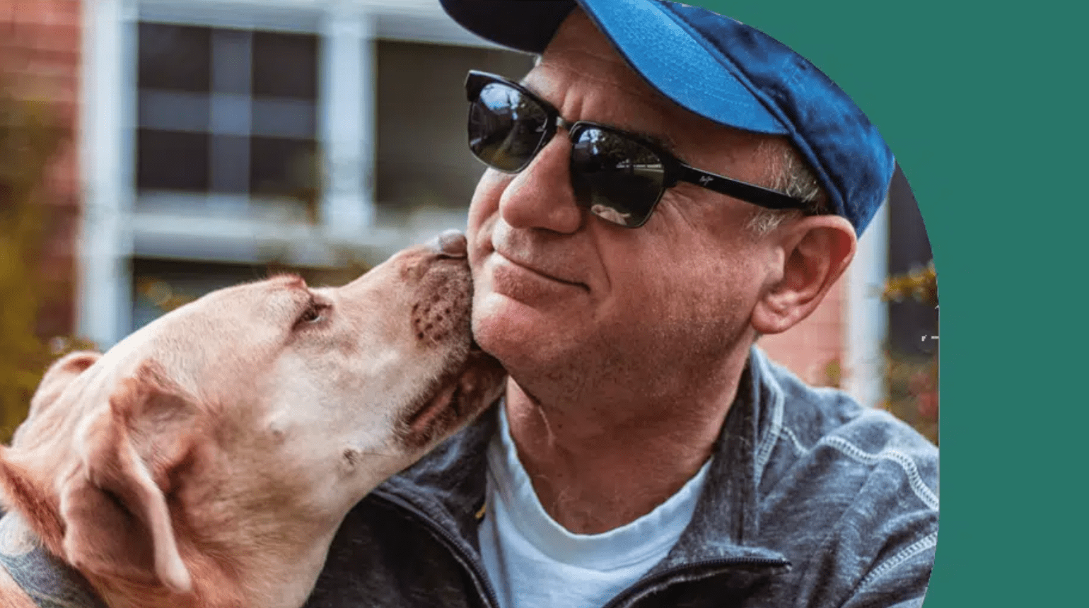 A dog licking a mans cheek.