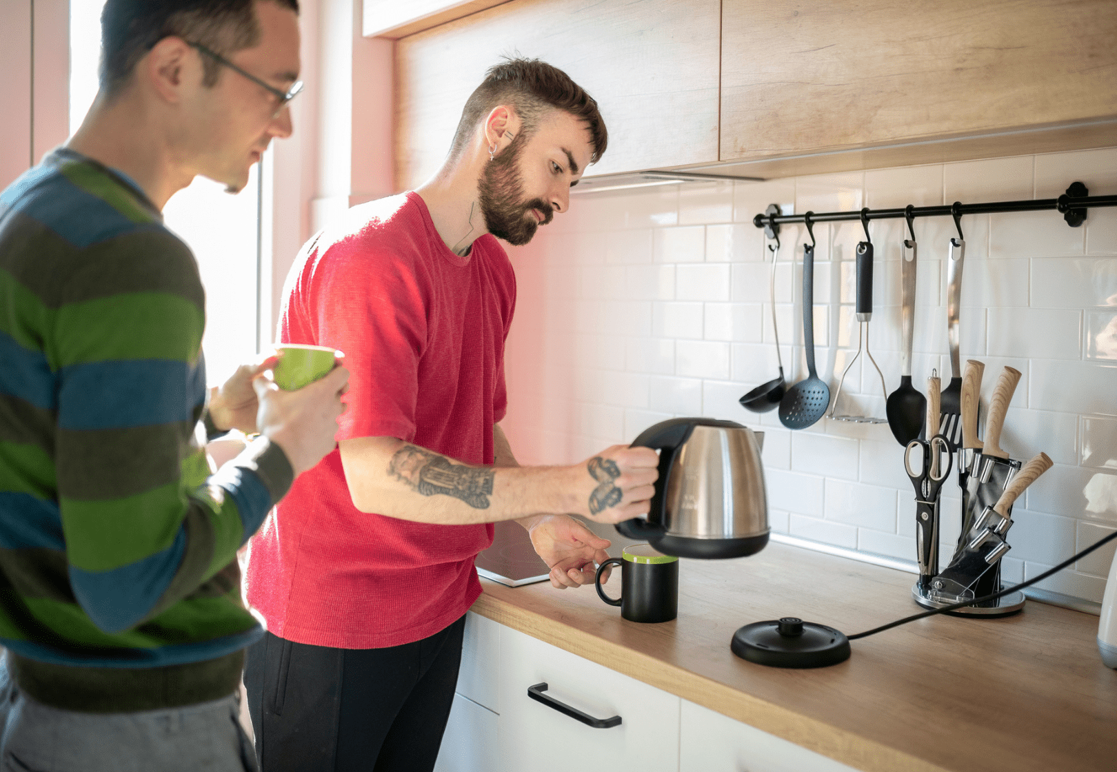Two men in the kitchen with a kettle