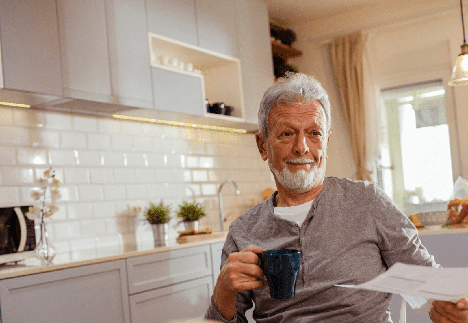 Man drinking coffee and filing out paperwork