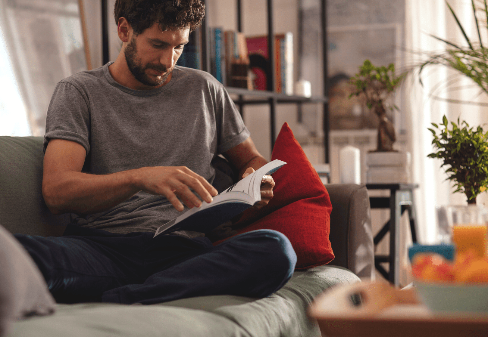 Man reading a book on the couch