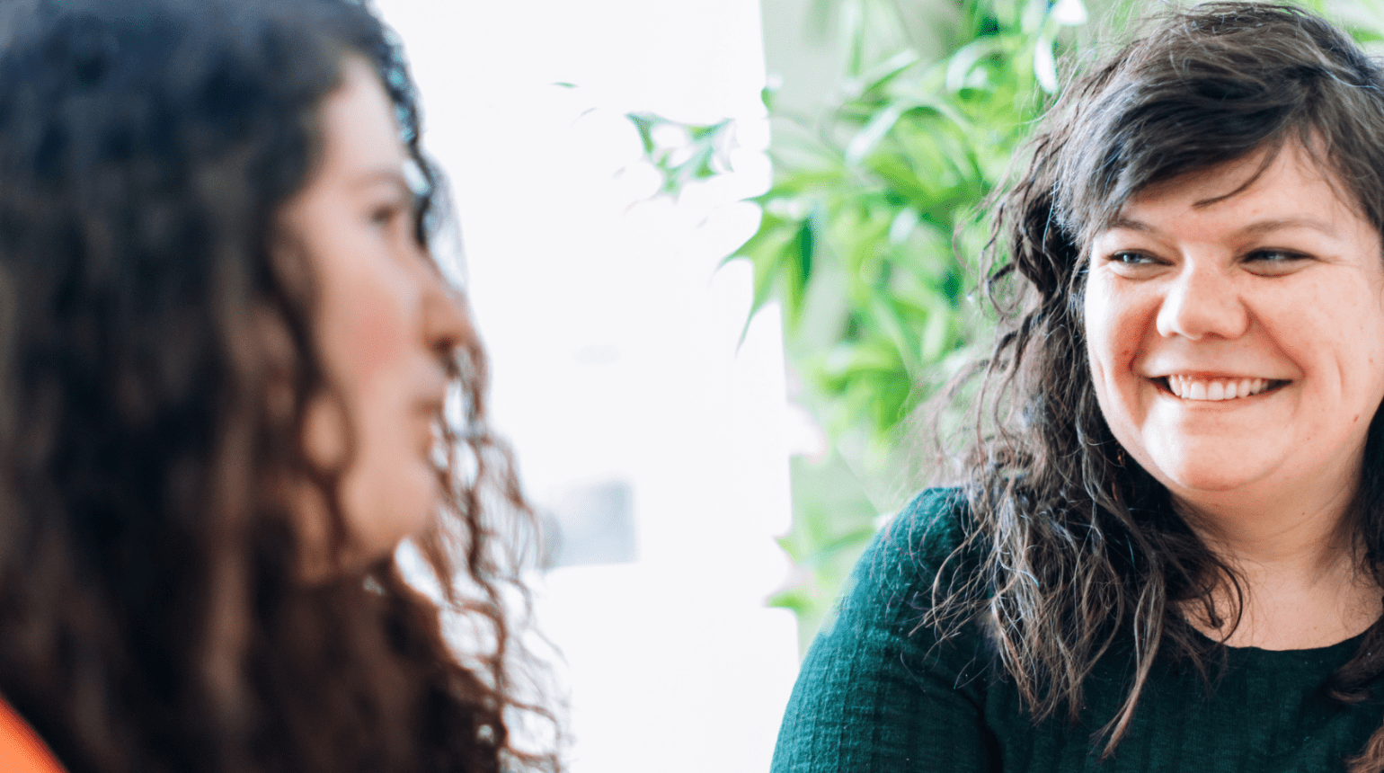 Two women talking and smiling