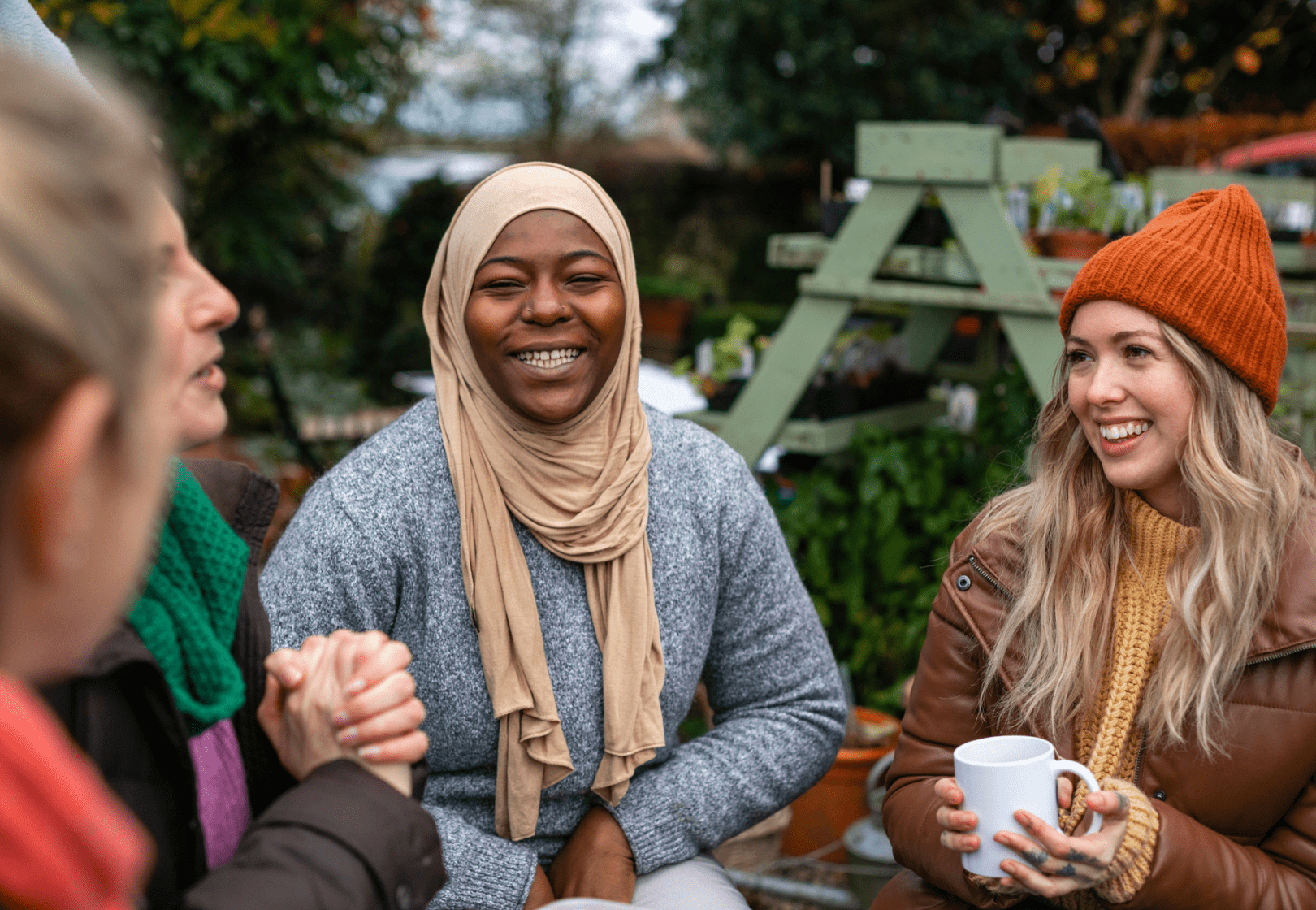 Four women outside talking while warmly dressed