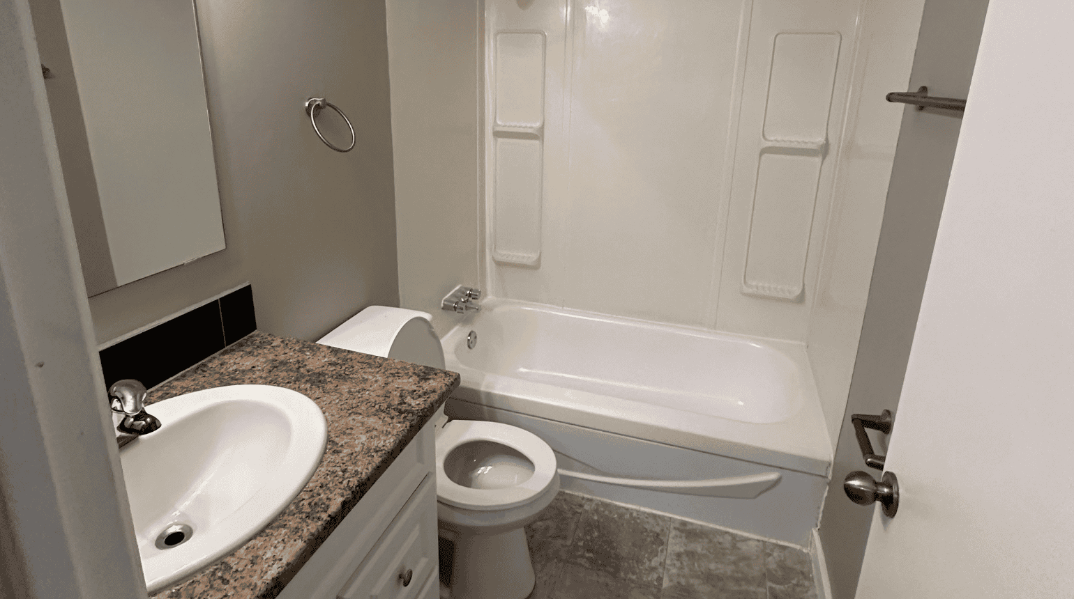 Bathroom with vanity, toilet and bathtub.