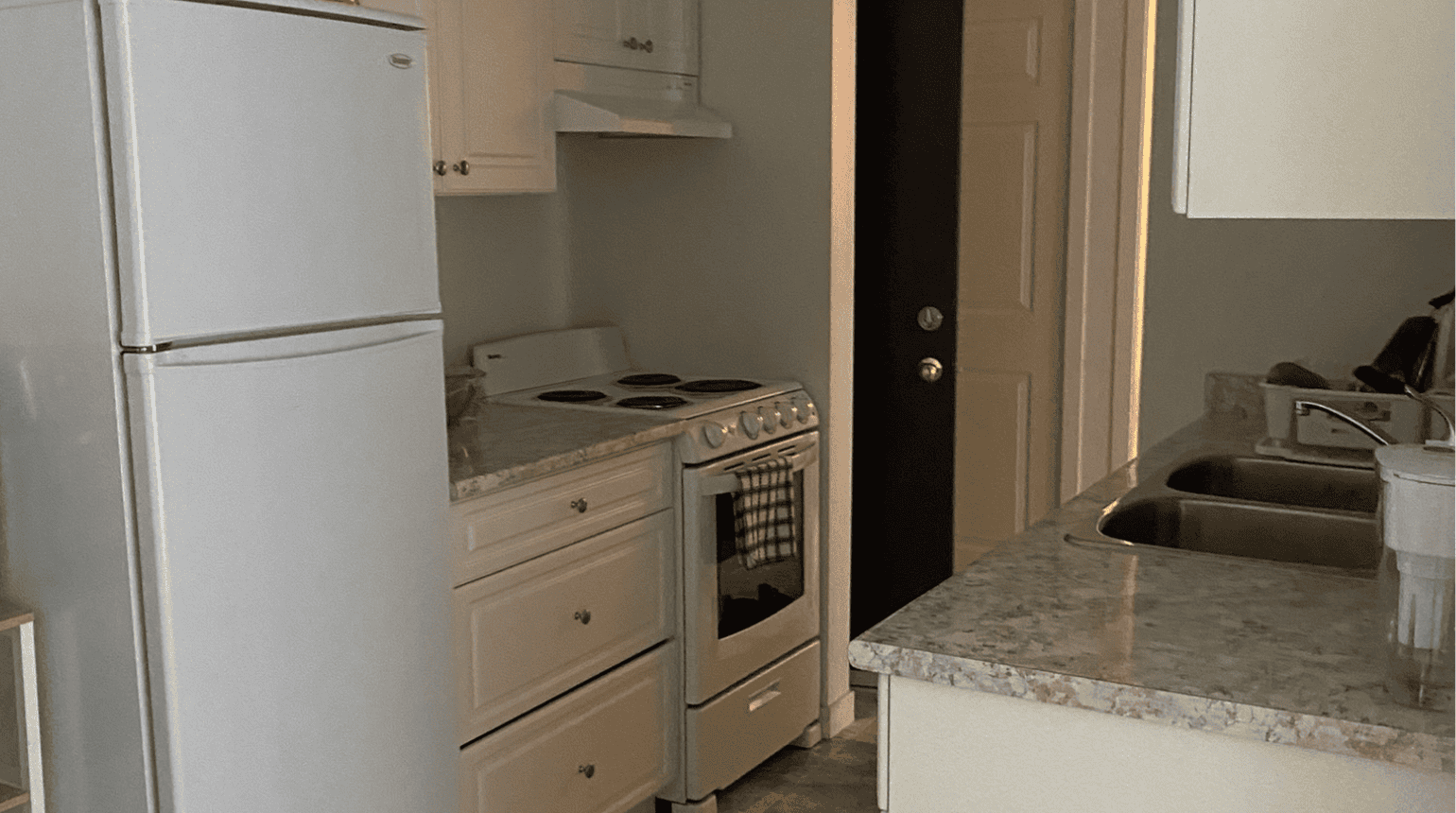 Kitchen with white cabinets and appliances