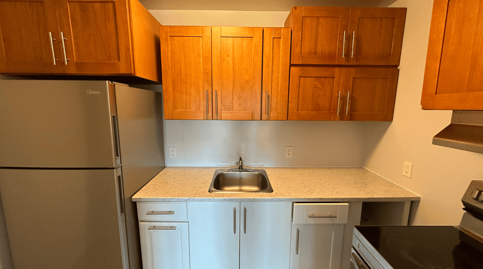 Kitchen with sink, fridge and stove