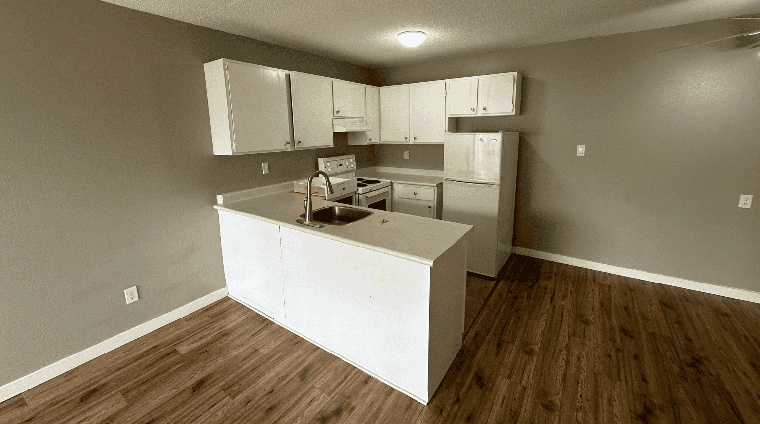 Kitchen with white cabinets and white appliances