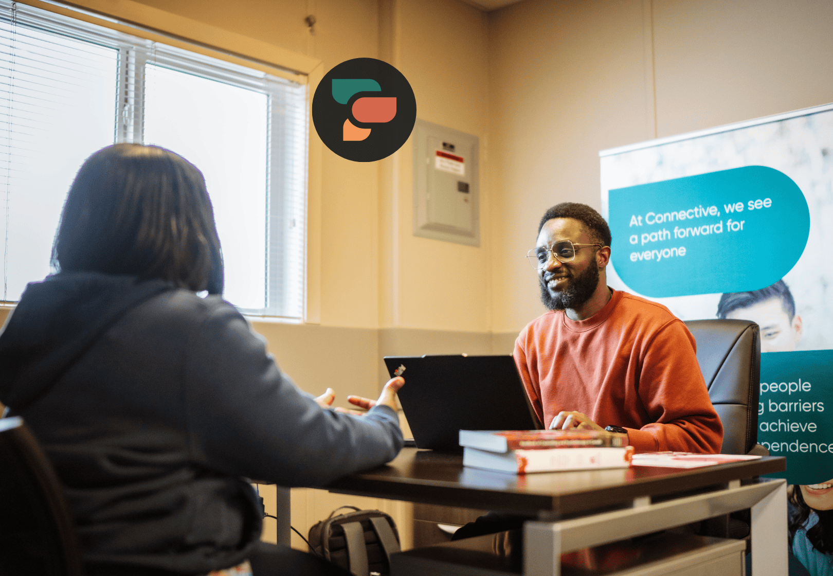Two people sitting across from each other talking.
