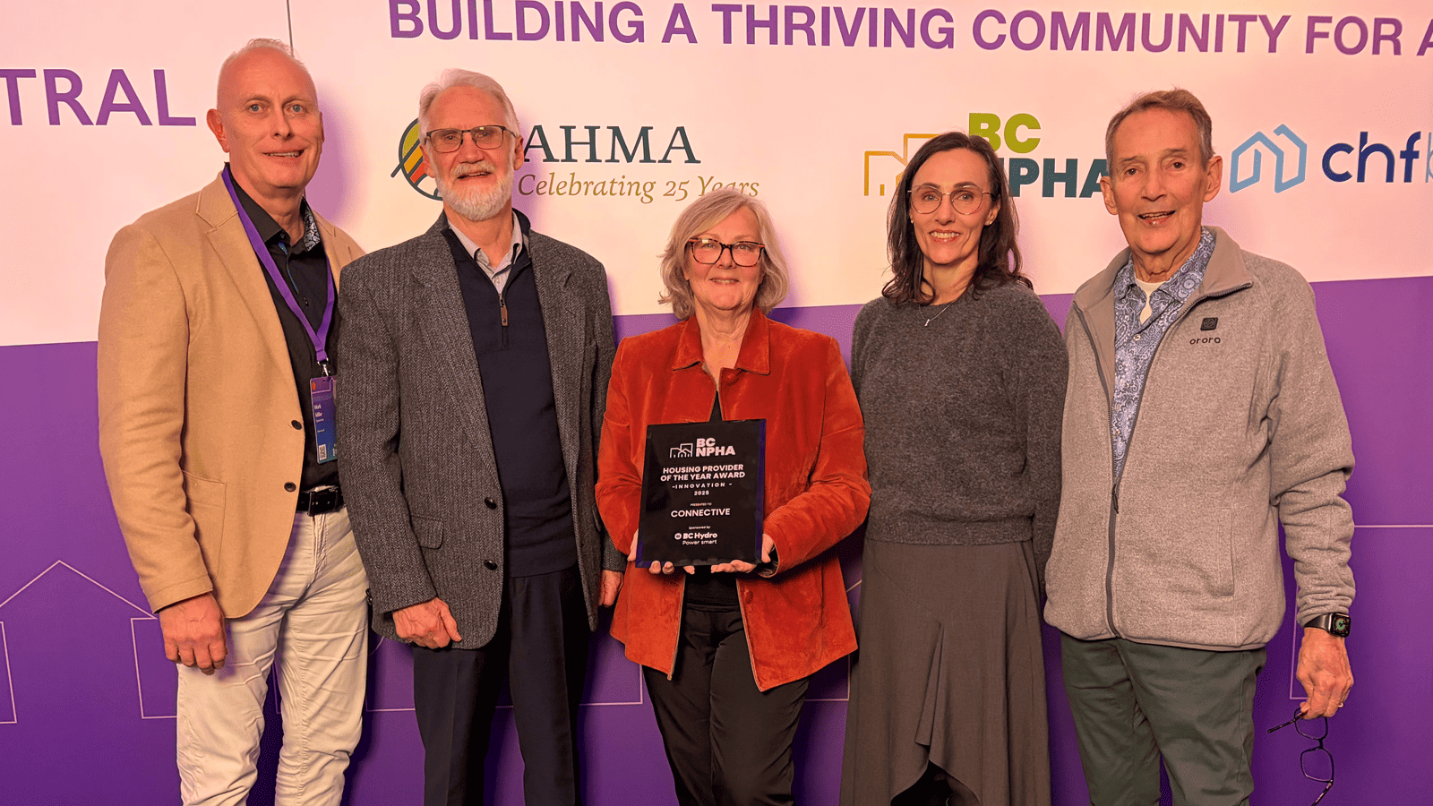 Connective's CEO, Mark Miller, posing with members of the Board of Directors and the Housing Provider of the Year Award.